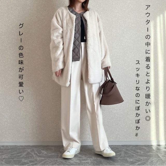 アウターの中にキルティングベストを着た女性