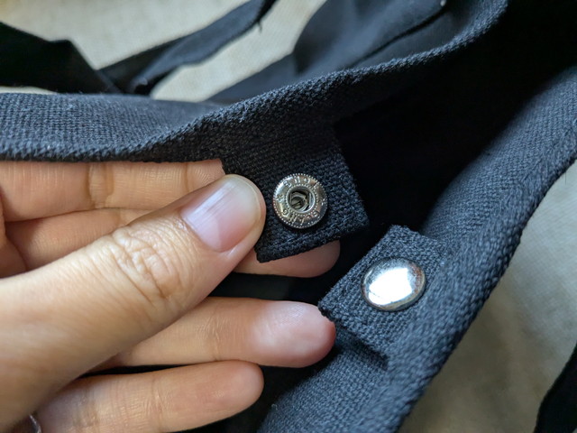 BAYFLOWトートの開口部スナップボタンをつまんでいるアップ