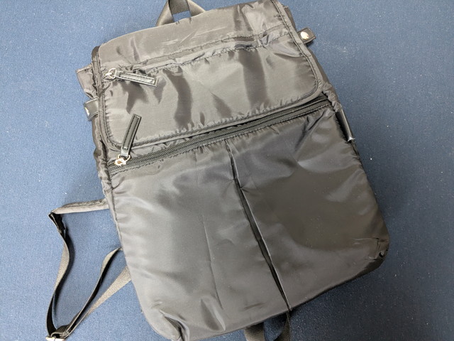 Y'SACCSデイリーリュック前面全体。上部にフラップポケット、中央にファスナーポケット、下部に2つのスリットポケットがある