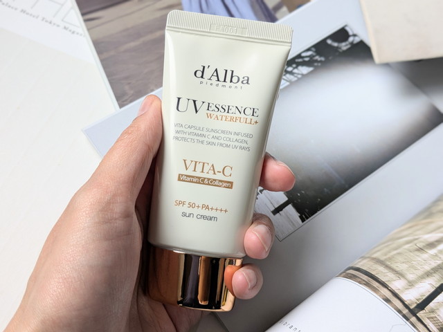 d'AlbaのUVエッセンスウォータフルVITA-Cサンクリームを手に持ったようす